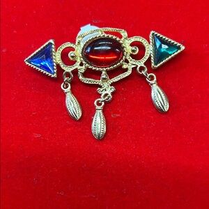 Elegant Gold and Red Brooch with Blue Accents